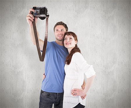 simsearch:400-07957339,k - Couple using camera for picture against weathered surface Photographie de stock - Aubaine LD & Abonnement, Code: 400-07957324