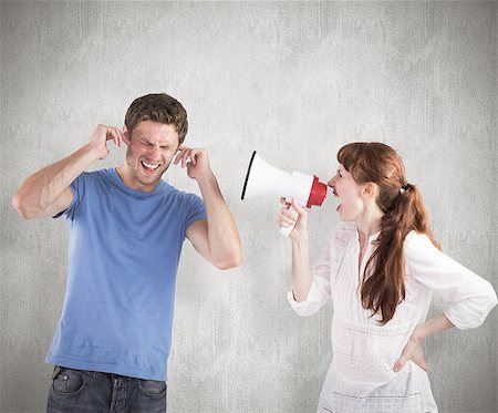 simsearch:400-06687238,k - Woman shouting through a megaphone against weathered surface Fotografie stock - Microstock e Abbonamento, Codice: 400-07957326