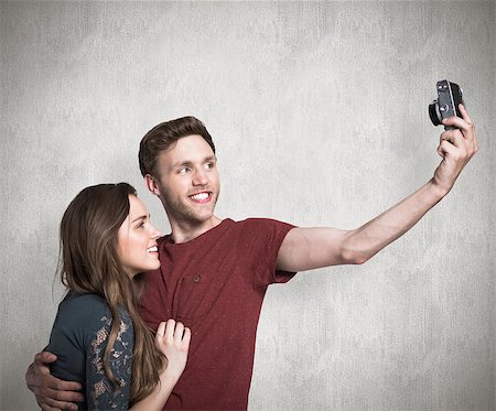Couple taking selfie with digital camera against weathered surface Photographie de stock - Aubaine LD & Abonnement, Code: 400-07957374