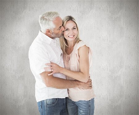 simsearch:400-07957460,k - Affectionate man kissing his wife on the cheek against weathered surface Foto de stock - Super Valor sin royalties y Suscripción, Código: 400-07957391