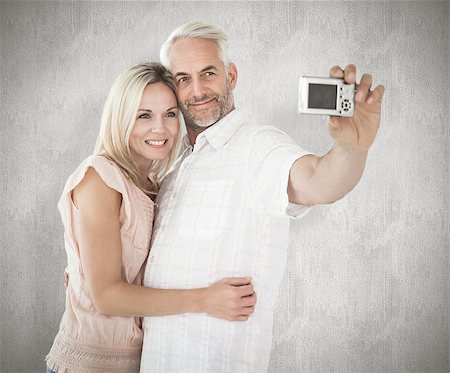 simsearch:400-07957627,k - Happy couple posing for a selfie against weathered surface Foto de stock - Super Valor sin royalties y Suscripción, Código: 400-07957393