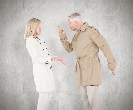 simsearch:400-07685942,k - Angry couple fighting in trench coats against white background Photographie de stock - Aubaine LD & Abonnement, Code: 400-07957485