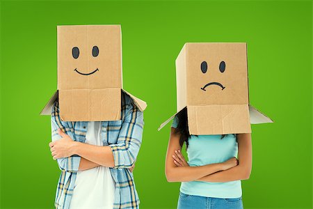 Young couple wearing sad face boxes over head against green vignette Stock Photo - Budget Royalty-Free & Subscription, Code: 400-07957537