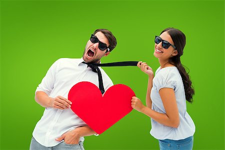 simsearch:400-07957006,k - Brunette pulling her boyfriend by the tie holding heart against green vignette Stock Photo - Budget Royalty-Free & Subscription, Code: 400-07957541