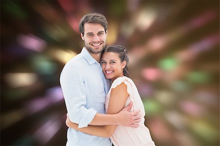 simsearch:400-07957805,k - Attractive young couple hugging and smiling at camera against valentines heart design Photographie de stock - Aubaine LD & Abonnement, Code: 400-07957787