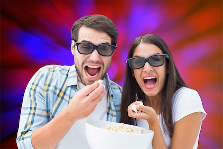 simsearch:400-07957006,k - Attractive young couple watching a 3d movie against valentines heart pattern Stock Photo - Budget Royalty-Free & Subscription, Code: 400-07957804