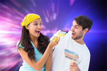 simsearch:400-07957006,k - Happy young couple painting together and laughing against valentines heart design Stock Photo - Budget Royalty-Free & Subscription, Code: 400-07957806