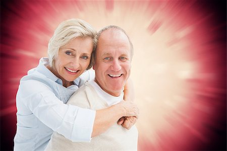 simsearch:400-07957212,k - Happy mature couple smiling at camera against valentines heart design Stock Photo - Budget Royalty-Free & Subscription, Code: 400-07957812
