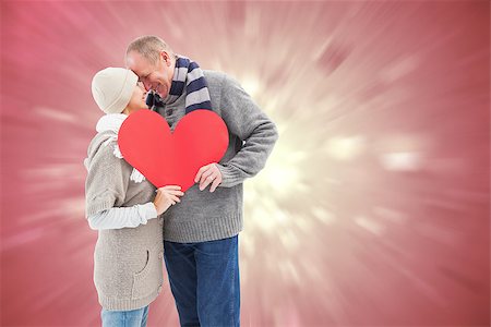 simsearch:400-07957212,k - Happy mature couple in winter clothes holding red heart against valentines heart design Stock Photo - Budget Royalty-Free & Subscription, Code: 400-07957813