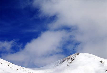 Paraglider silhouette of mountains in windy sky. Caucasus Mountains. Georgia, ski resort Gudauri. Foto de stock - Super Valor sin royalties y Suscripción, Código: 400-07951307