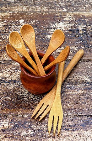 Arrangement of Small Wooden Spoons in Pot and Wooden Forks isolated on Rustic Wooden background Stock Photo - Budget Royalty-Free & Subscription, Code: 400-07951334