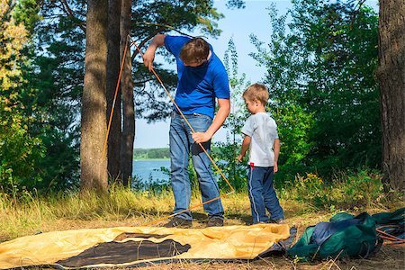 father son camping woods - father and son set the tent on the lake Stock Photo - Budget Royalty-Free & Subscription, Code: 400-07952106
