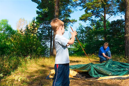 father son camping woods - little son helps to establish a tent on the nature Stock Photo - Budget Royalty-Free & Subscription, Code: 400-07952107
