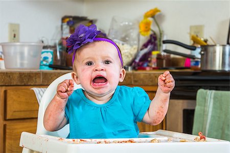 A baby girl throws a tantrum in the kitchen Stock Photo - Budget Royalty-Free & Subscription, Code: 400-07952660