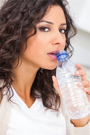 simsearch:400-07920877,k - Beautiful young Latina Hispanic woman smiling, relaxing and drinking a bottle of water Stock Photo - Budget Royalty-Free & Subscription, Code: 400-07975574