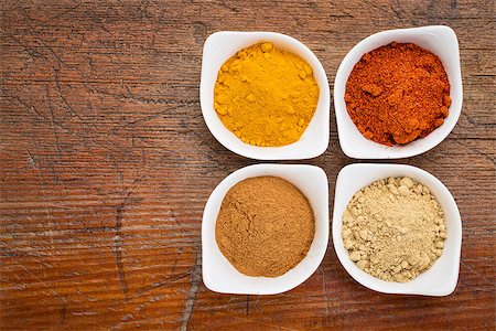 simsearch:400-07300783,k - four healthy spices (turmeric, ginger, cinnamon and paprika) in white bowls on a grunge wood Stockbilder - Microstock & Abonnement, Bildnummer: 400-07976542
