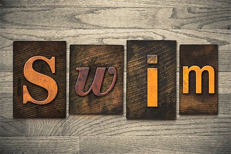 The word "SWIM" written in wooden letterpress type. Foto de stock - Royalty-Free Super Valor e Assinatura, Número: 400-07977131