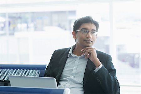 Asian Indian business man waiting his flight at airport. Stock Photo - Budget Royalty-Free & Subscription, Code: 400-07978341