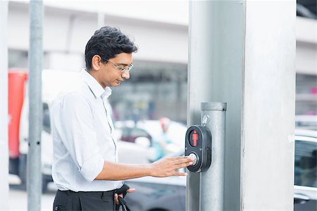 Asian Indian people hand pushing a crosswalk button at a traffic signal. Stock Photo - Budget Royalty-Free & Subscription, Code: 400-07978364