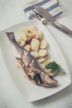 fresh seabass cooked with potatoes and lemon Stock Photo - Budget Royalty-Free & Subscription, Code: 400-07978765