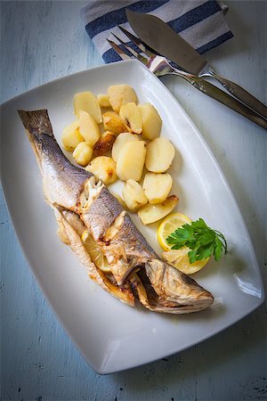 fresh seabass cooked with potatoes and lemon Stock Photo - Budget Royalty-Free & Subscription, Code: 400-07978766