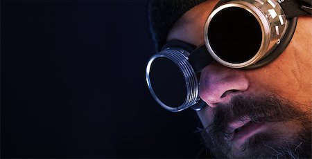 Shag beard and mustache man with goggles overlooking copy space Stock Photo - Budget Royalty-Free & Subscription, Code: 400-07978829