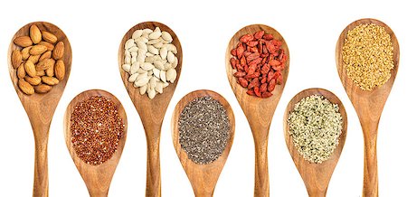 superfood abstract - isolated wooden spoons with almonds, red quinoa grain, pumpkin seeds, chia seeds, goji berry, hemp seed hearts, and golden flax seed Stock Photo - Budget Royalty-Free & Subscription, Code: 400-07979209