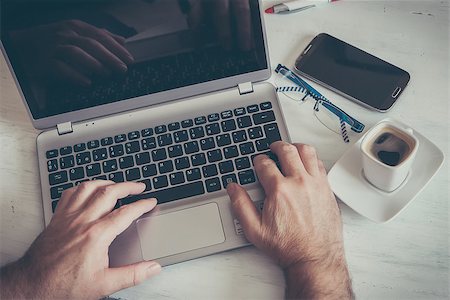 a coffeee cup on white table and laptop Stock Photo - Budget Royalty-Free & Subscription, Code: 400-07979314