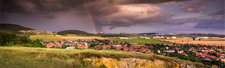 Landscape with Several Populated Areas under Cloudy Sky and Rainbow Stock Photo - Budget Royalty-Free & Subscription, Code: 400-07979579