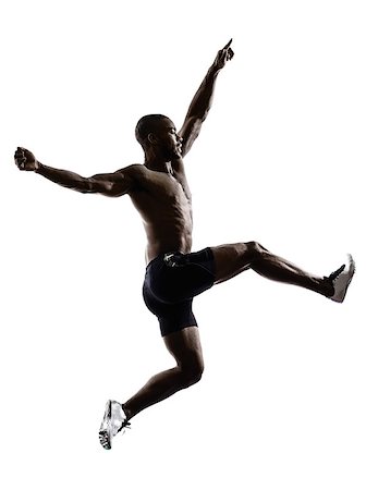 salto in lungo - one young african muscular build man jumping running silhouette isolated on white background Fotografie stock - Microstock e Abbonamento, Codice: 400-07973112