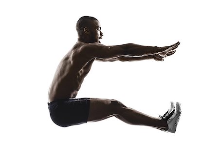 salto in lungo - one young african muscular build man long jumping silhouette isolated on white background Fotografie stock - Microstock e Abbonamento, Codice: 400-07973113