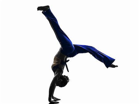 salto - one  woman capoeira dancer dancing in silhouette studio isolated on white background Stockbilder - Microstock & Abonnement, Bildnummer: 400-07973205