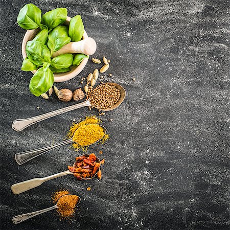 simsearch:400-04348087,k - basil in a wooden mortar and spices spoons on a black background Stock Photo - Budget Royalty-Free & Subscription, Code: 400-07973605