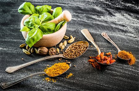 simsearch:400-04348087,k - basil in a wooden mortar and spices on a black table Stock Photo - Budget Royalty-Free & Subscription, Code: 400-07973603