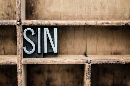 The word "SIN" written in vintage metal letterpress type in a wooden drawer with dividers. Stock Photo - Budget Royalty-Free & Subscription, Code: 400-07984144