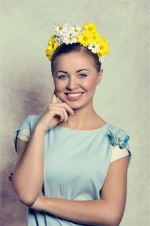 simsearch:400-07986693,k - Beautiful, charming, fresh, spring woman in baby blue dress with little butterfly and wreath of flowers on her head. Stock Photo - Budget Royalty-Free & Subscription, Code: 400-07984613