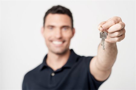 Real estate agent showing new house key Stock Photo - Budget Royalty-Free & Subscription, Code: 400-07984877
