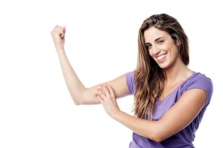 Beautiful charming girl flexing her biceps Stock Photo - Budget Royalty-Free & Subscription, Code: 400-07985449
