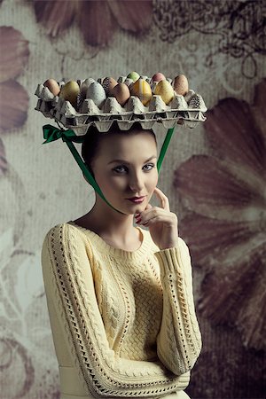 lovely woman with yellow clothes posing in creative easter portrait with bizarre hat with coloured eggs in carton box Stock Photo - Budget Royalty-Free & Subscription, Code: 400-07985823