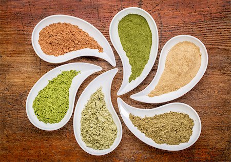 nutirtion supplement abstract - a top view of teardrop shaped bowls of various powders - cacao, wheatgrass, maca root, hemp protein, kelp, moringa leaf Photographie de stock - Aubaine LD & Abonnement, Code: 400-07985956