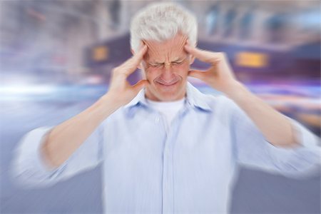 Man with headache against blurred new york street Stock Photo - Budget Royalty-Free & Subscription, Code: 400-07986290
