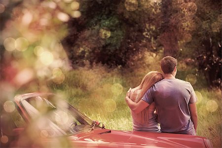 Loving couple admiring nature while leaning on their cabriolet on a sunny day Stock Photo - Budget Royalty-Free & Subscription, Code: 400-07986343