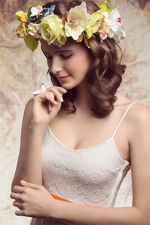 simsearch:400-07986693,k - Beautiful, brunette woman with colorful makeup, wreath of flowers on head, little bird on her finger and wearing white dress. Stock Photo - Budget Royalty-Free & Subscription, Code: 400-07986696