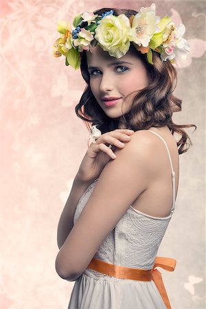 Romantic, natural, pretty brunette woman with wreath of flower and little bird on her finger. She wears white dress and colorful makeup. Photographie de stock - Aubaine LD & Abonnement, Code: 400-07986697