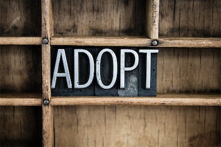 The word "ADOPT" written in vintage metal letterpress type in a wooden drawer with dividers. Stock Photo - Budget Royalty-Free & Subscription, Code: 400-07986790