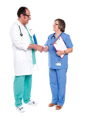 doctor shaking hands full body - Senior doctors performing handshake. Operation successful. Congratulations Photographie de stock - Aubaine LD & Abonnement, Code: 400-07986986