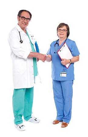 doctor shaking hands full body - Full body portrait of two medical representatives shaking hands Stock Photo - Budget Royalty-Free & Subscription, Code: 400-07986987