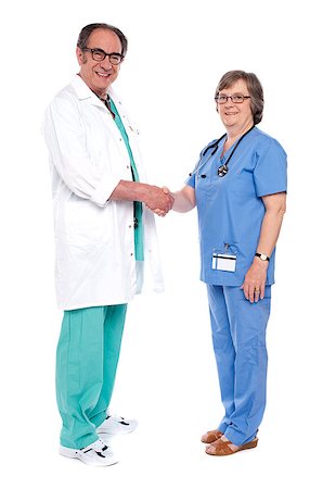 doctor shaking hands full body - Full body portrait of two senior medical persons shaking hands isolated on white background Stock Photo - Budget Royalty-Free & Subscription, Code: 400-07986994