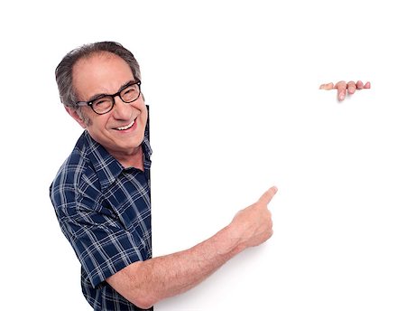 simsearch:400-06695536,k - Man pointing at white blank poster and smiling. Wearing eyeglasses Stock Photo - Budget Royalty-Free & Subscription, Code: 400-07987037
