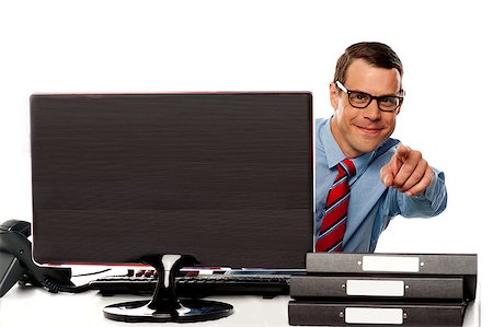 Male executive in glasses pointing at camera sitting in front of computer screen Stock Photo - Budget Royalty-Free & Subscription, Code: 400-07987545